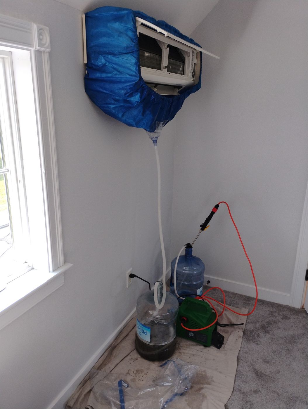Wall-mounted heat pump indoor unit protected during professional deep cleaning