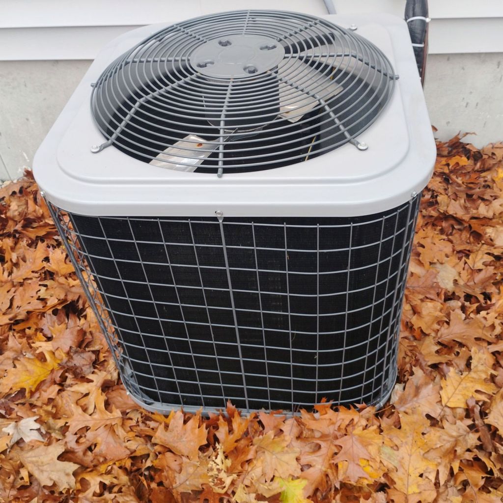 Residential outdoor air conditioning unit installed beside a home