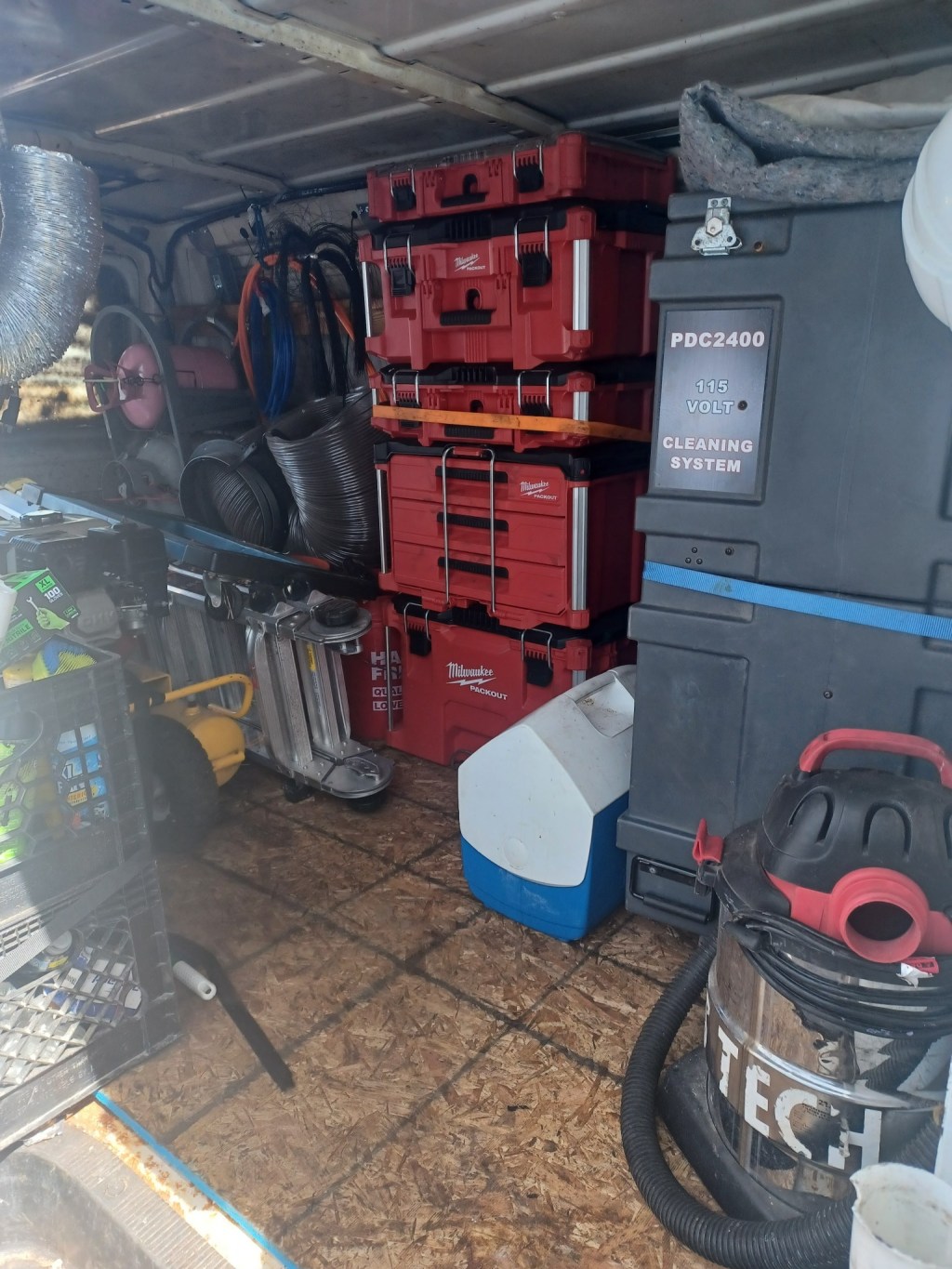 Professional duct and HVAC cleaning equipment stored in a service van